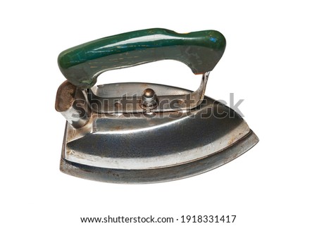 Old iron. Top view of old electric iron for ironing isolated on white background. Old household appliances. Selective soft focus.