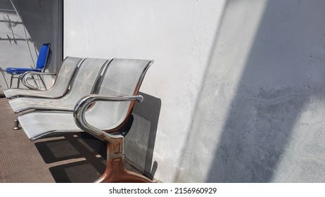 Old Iron Waiting Chair Under Bright Sun