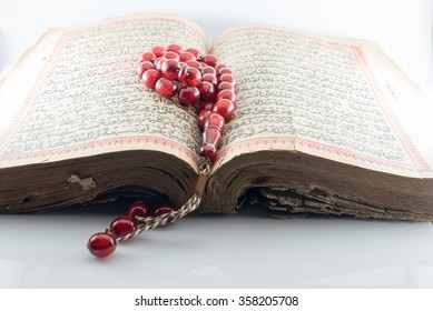  Old Islamic Book Holy Quran and beads on withe background