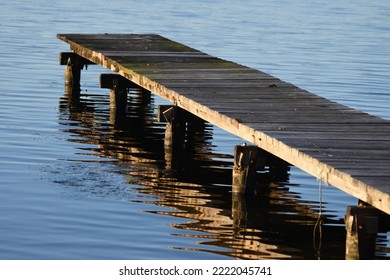 Old Jetty With Water Reflection