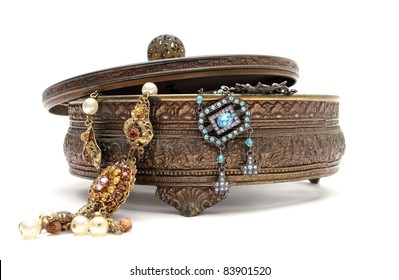 an old jewelery box with old jewels in it over a white background