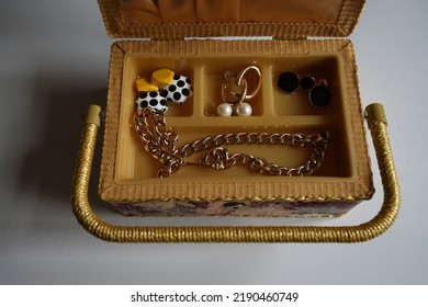 An Old Jewelry Box With Different Jewelry