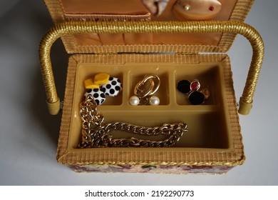 An Old Jewelry Box With Different Jewelry