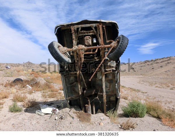 Old junk car sticker out of desert earth -\
landscape color photo