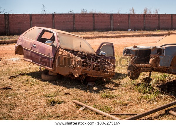 Old Junk Cars left on the side of the Road to\
deteriorate and rust out   
