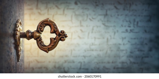 An Old Key In A Keyhole On The Background Of An Ancient Manuscript, Macro Photography. Retro Style. The Key To Knowledge. Concept And Idea For History, Education, Religion, Security Background.