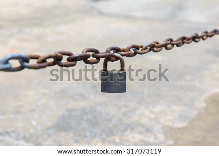 old key lock locked with a chain.
