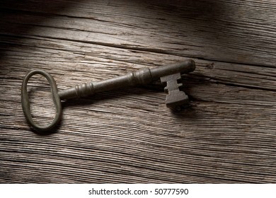 Old Key On Textured Wood