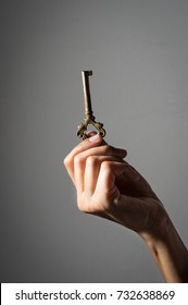 Old Key In Woman Hand.