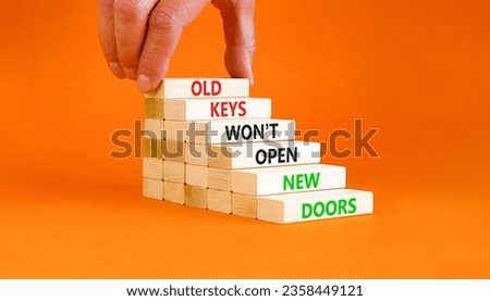 Old keys do not open new doors symbol. Concept words Old keys do not open new doors. Beautiful orange table background. Businessman hand. Business popular quotation old key new door concept Copy space