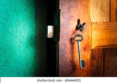 Old Keys On Half Open Door. Security And Safety Concept