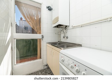 Old Kitchen With Wooden Door To A Terrace, Natural Gas Heater And Terrazzo Floors