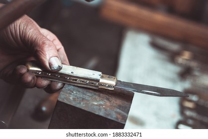 Old knife maker at work.