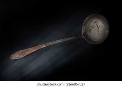 Old Ladle On A Dark Background