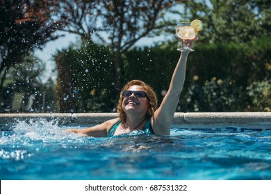 Old Lady With A Cocktail In The Pool