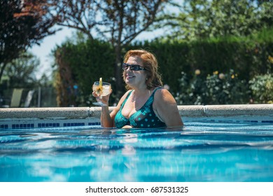 Old Lady With A Cocktail In The Pool