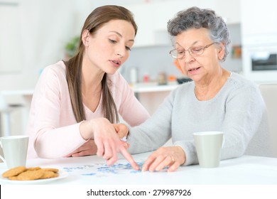 Old Lady Doing A Jigsaw Puzzle