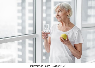 Old Lady Eating Fruit With Enjoyment