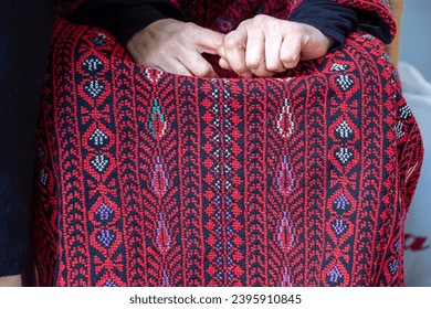 old lady hands wearing palestinian clothes feeling nervous about her relatives and family