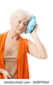 An Old Lady With Ice Bag By Her Head. Isolated On White. 