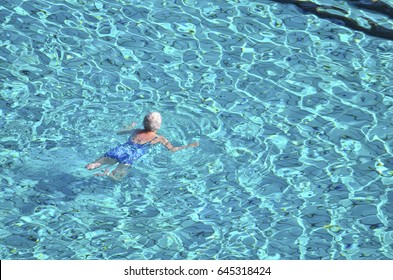 Old Lady Swimming In Swimming Pool.