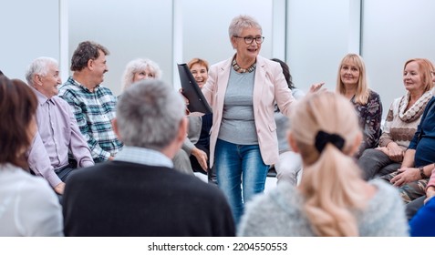 old lady teaches old people - Shutterstock ID 2204550553