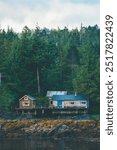 Old lake house in the middle of Alaska’s wilderness, hidden in a dense forest on the coast of Ketchikan