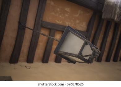 Old Lamppost Hanging Under A Porch, Seen From Below, Porch With Exposed Wood Beams