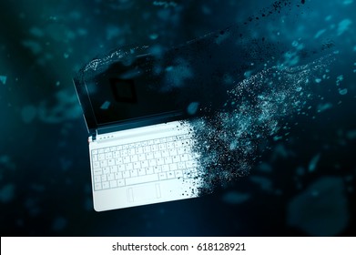 The old laptop is disintegrating in space. Conception of passage of time and obsolete technology