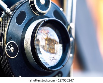 Old large format camera on a city street background.Vintage light.Selective focus.