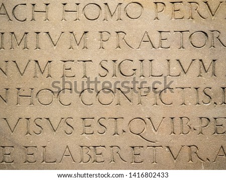 Old Latin text engraved on stone latin characters words
