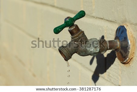 Old leaky dripping faucet, hose bibb