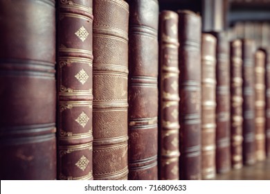 Old leather bound vintage books in a row - Shutterstock ID 716809633