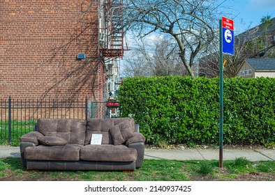 A Old Leather Couch Discarded On Street Side For Free To Be Taken Away By A No-standing Sign Of Bus Stop