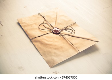 Old Letter Envelope With Wax Seal On Wooden Surface