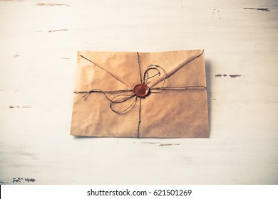 Old Letter Envelope With Wax Seal On Wooden Surface