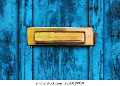 Old letterbox or mailbox slot on worn wooden blue door with paint peeling off - Powered by Shutterstock