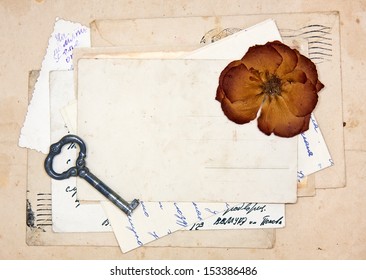 old letters, empty post cards and dried rose, vintage background