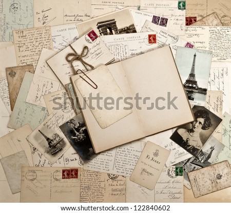 old letters, french post cards and empty open diary book. nostalgic vintage background
