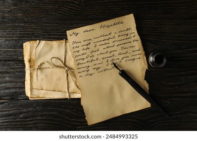 Old letters, letter with text and pen on wooden background, top view