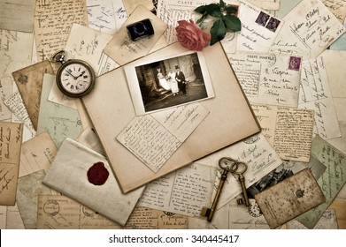 Old letters, photographs and postcards. Nostalgic vintage wedding background. Retro style toned picture