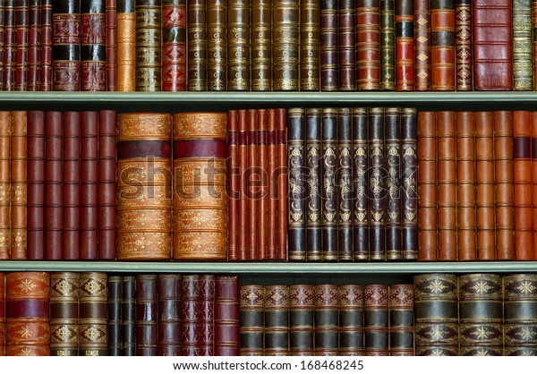 Old library of vintage hard cover books on shelves