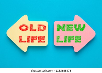 Old Life and New Life written on paper arrows. New life concept, dieting, healthy lifestyle and new year resolution. 