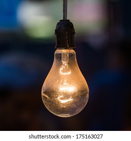 Old Light Bulb Glowing In Dark