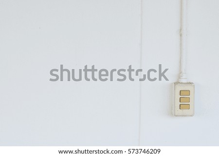 Old light switch on a white wall