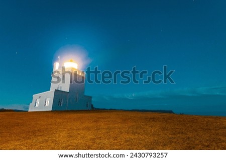 The old lighthouse in Dyrhólaey illuminates the safe way for sailors to sail south of Iceland