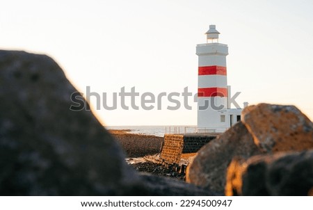 The old lighthouse in Garður at Reykjanes Peninsula Iceland during sunset or sunrise. Travel photo. Popular tourist attraction in Iceland