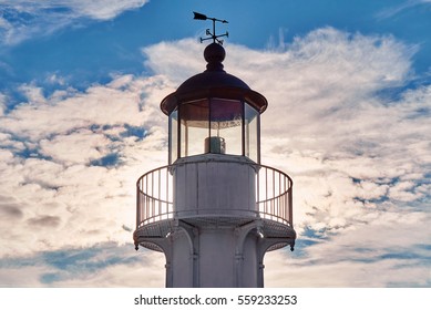 Old lighthouse at sunset against the backdrop of the sea port close-up
                                - Powered by Shutterstock