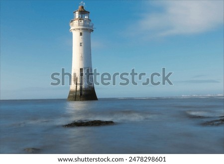 Old lighthouse as the tide comes in over the rocks