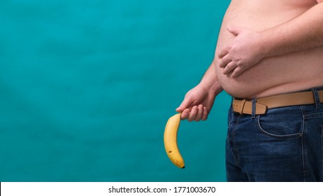 old limp drooping banana hanging from genital area of clothed unrecognizable man, impotence erectile dysfunction or limp-dick concept